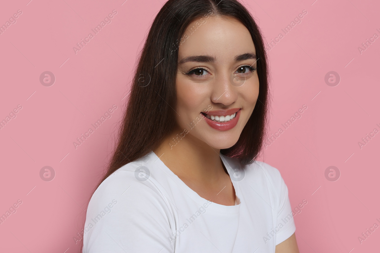 Photo of Portrait of beautiful young woman with elegant makeup on pink background