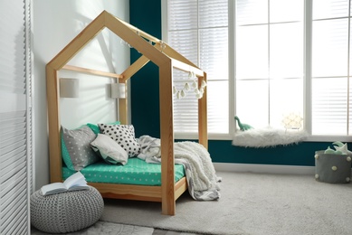 Cozy child room interior with comfortable bed