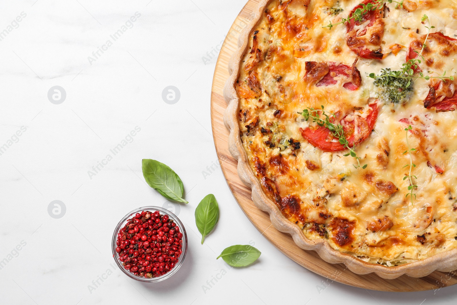 Photo of Tasty quiche with tomatoes, microgreens and cheese served on white table, flat lay. Space for text