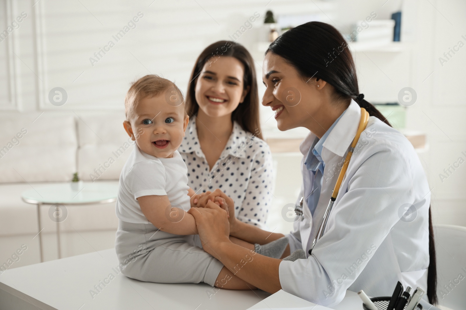 Photo of Mother with her cute baby visiting pediatrician in clinic