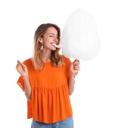 Photo of Happy young woman eating cotton candy on white background
