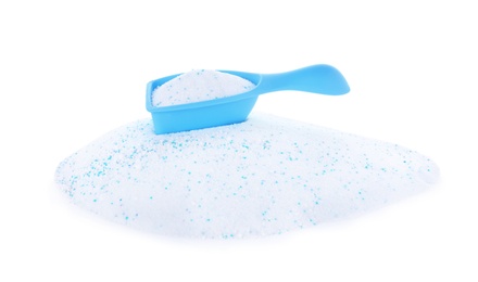 Measuring scoop with laundry powder on white background