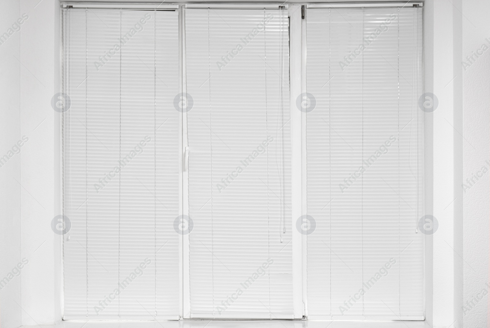 Photo of Window with closed modern horizontal blinds indoors