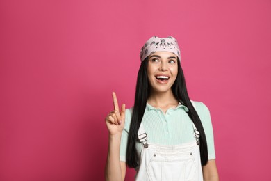 Photo of Young woman wearing stylish bandana on pink background, space for text