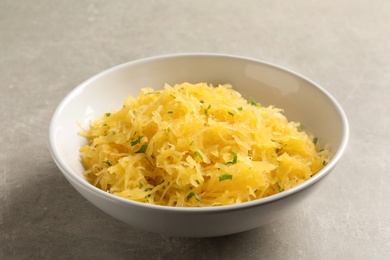 Bowl with cooked spaghetti squash on table