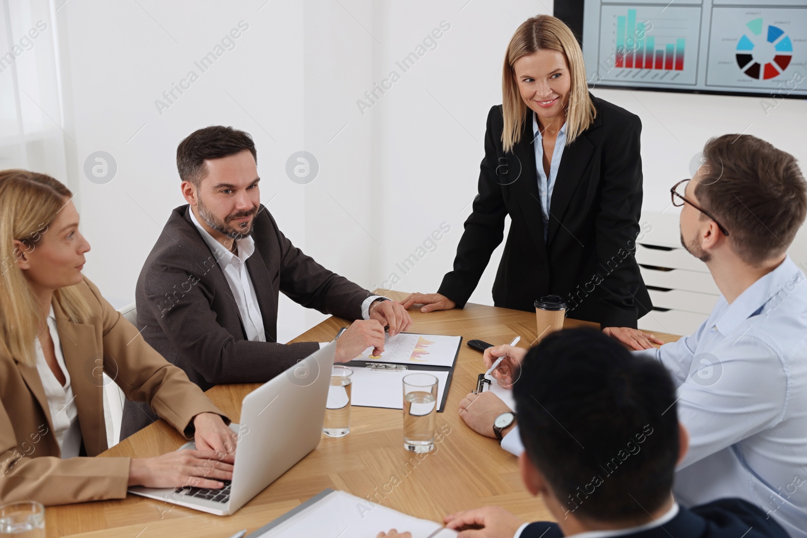 Photo of Businesswoman having meeting with her employees in office