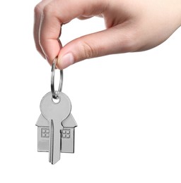 Photo of Woman holding key with keychain in shape of house isolated on white, closeup