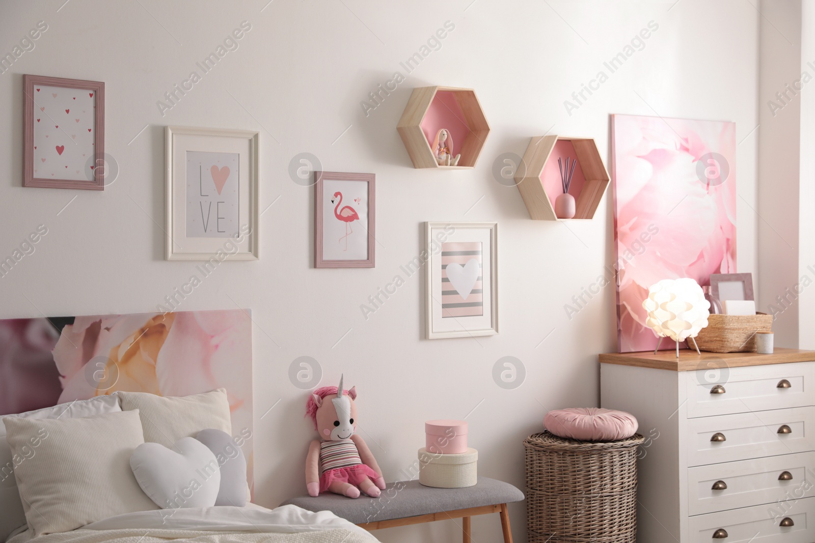 Photo of Stylish child's room interior with beautiful pictures and comfortable bed