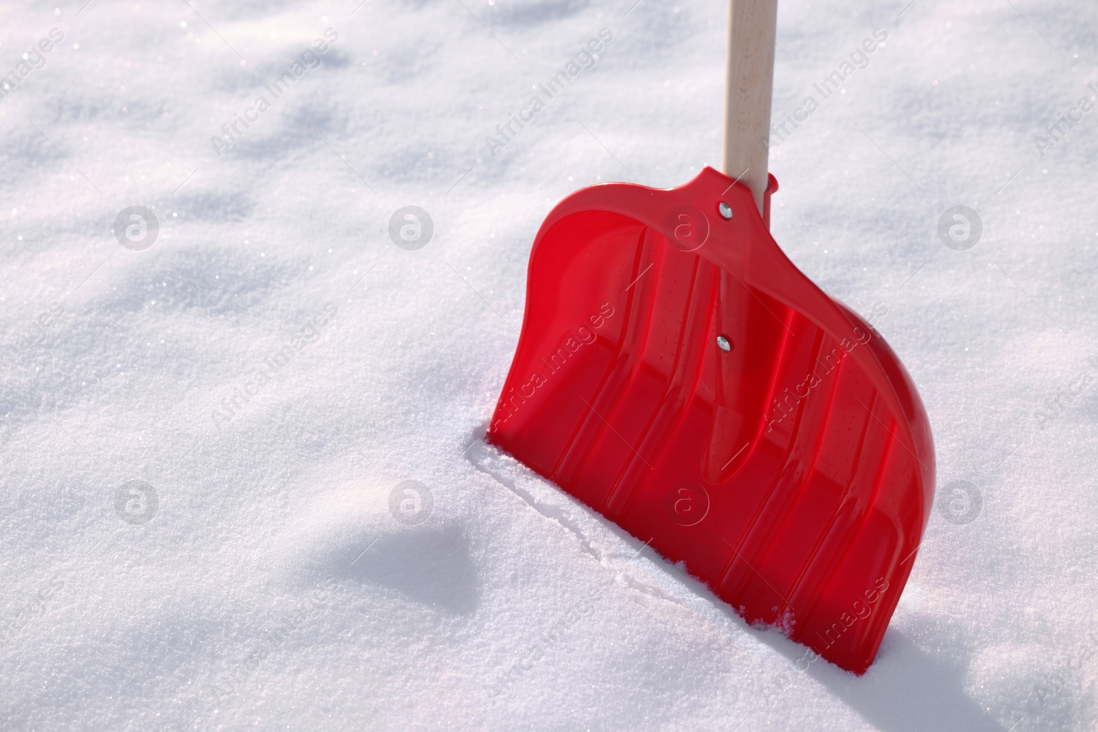 Photo of Snow shovel with wooden handle outdoors, closeup. Space for text