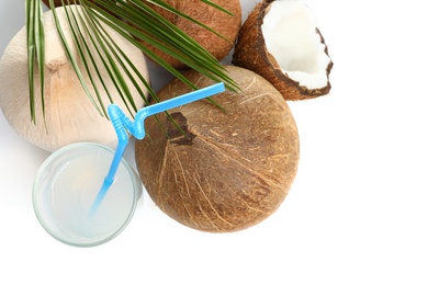 Photo of Glass of coconut milk and nuts on white background, top view