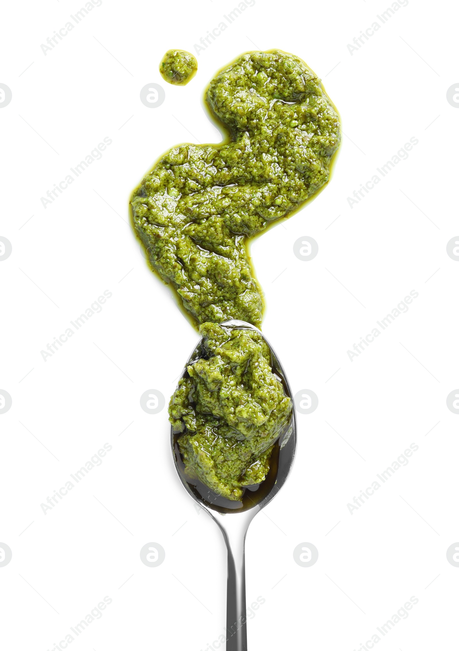 Photo of Sample of tasty pesto sauce and spoon isolated on white, top view