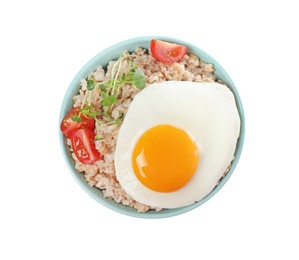 Photo of Tasty boiled oatmeal with fried egg, tomato and microgreens isolated on white, top view