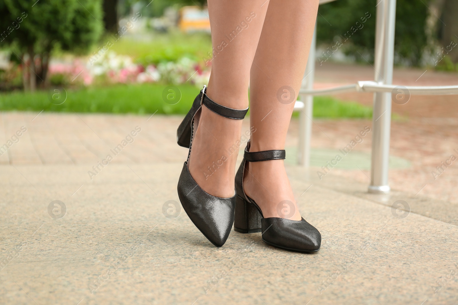 Photo of Woman wearing comfortable stylish shoes outdoors, closeup