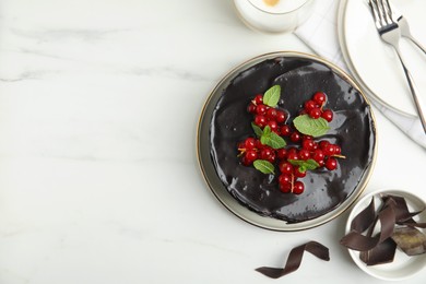 Photo of Tasty homemade chocolate cake with berries and mint on white marble table, flat lay. Space for text