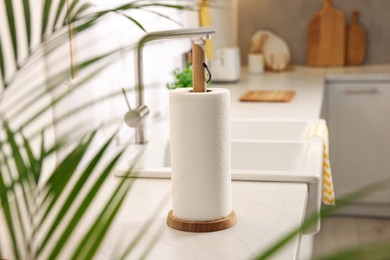 Photo of Roll of paper towels on white countertop in kitchen, space for text