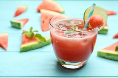 Photo of Delicious fresh watermelon drink on light blue wooden table, closeup