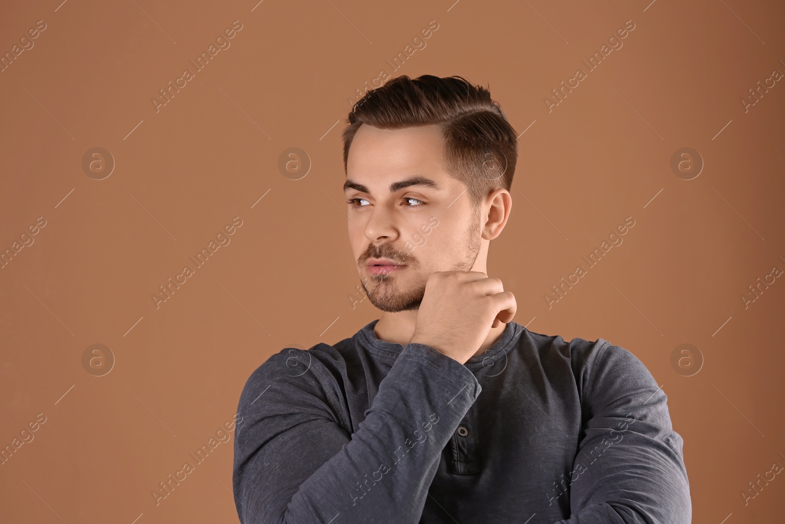 Photo of Portrait of young man with beautiful hair on color background