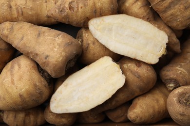 Tubers of turnip rooted chervil as background, top view