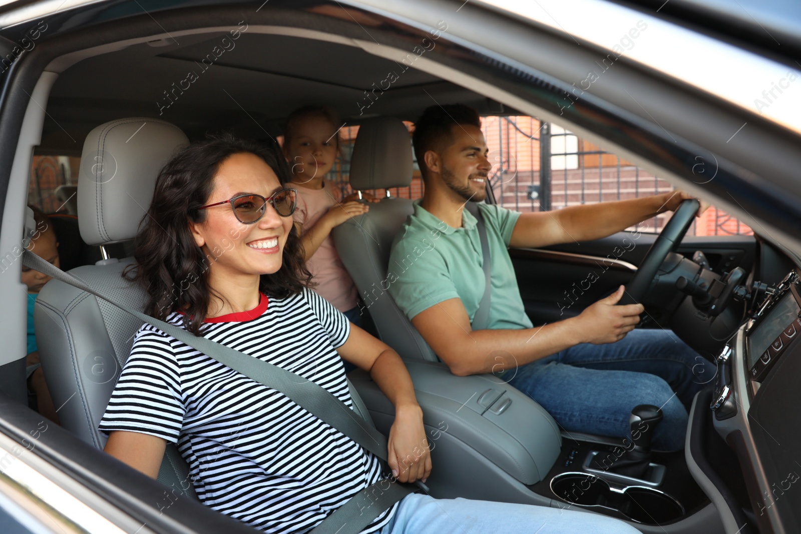 Photo of Happy family traveling by car on summer day