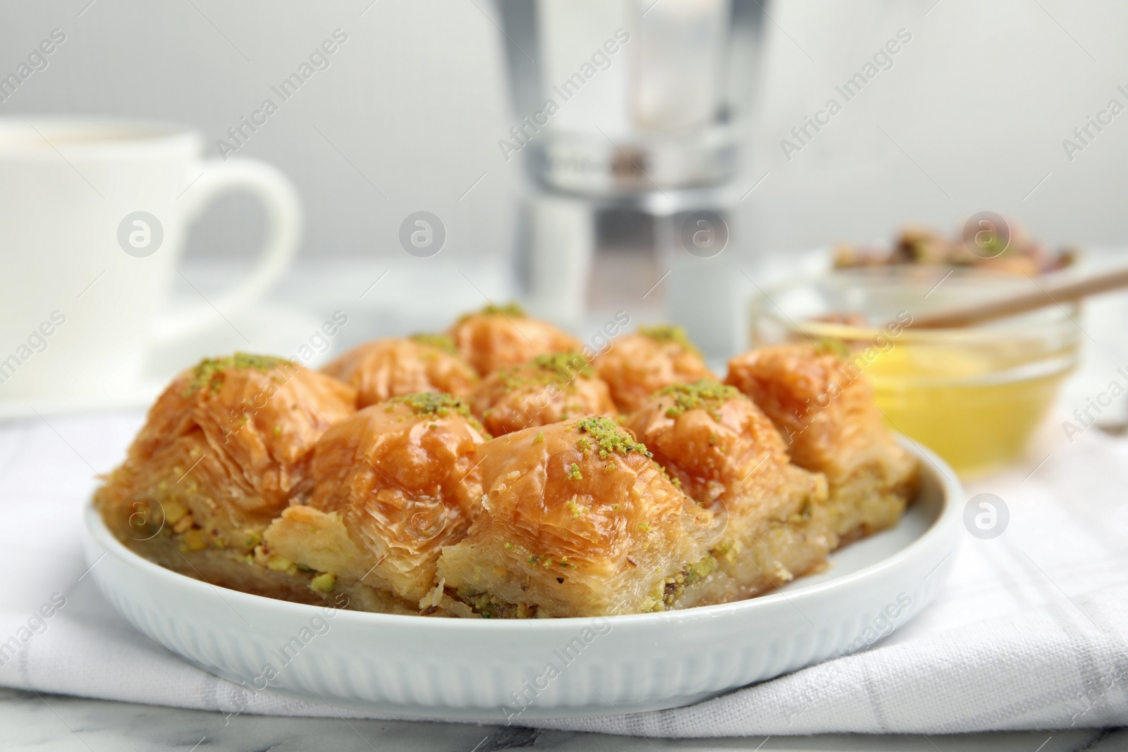 Photo of Delicious sweet baklava on white marble table, closeup