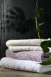 Photo of Stacked terry towels on table in bathroom