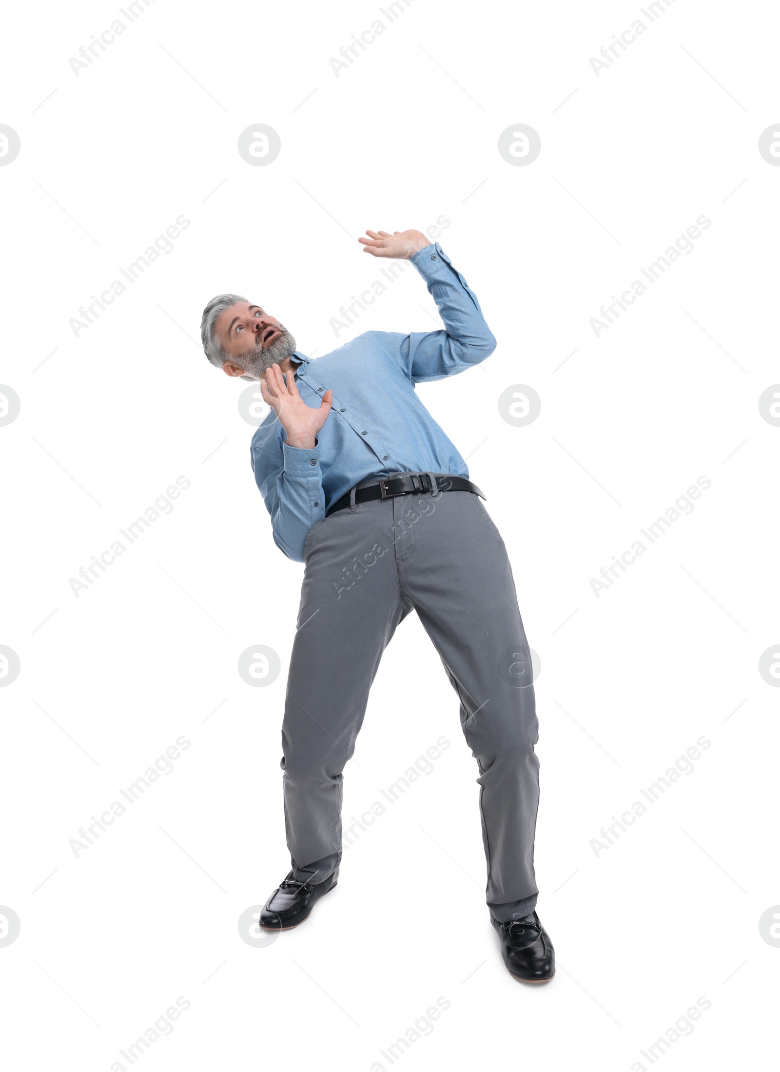 Photo of Mature businessman in stylish clothes avoiding something on white background