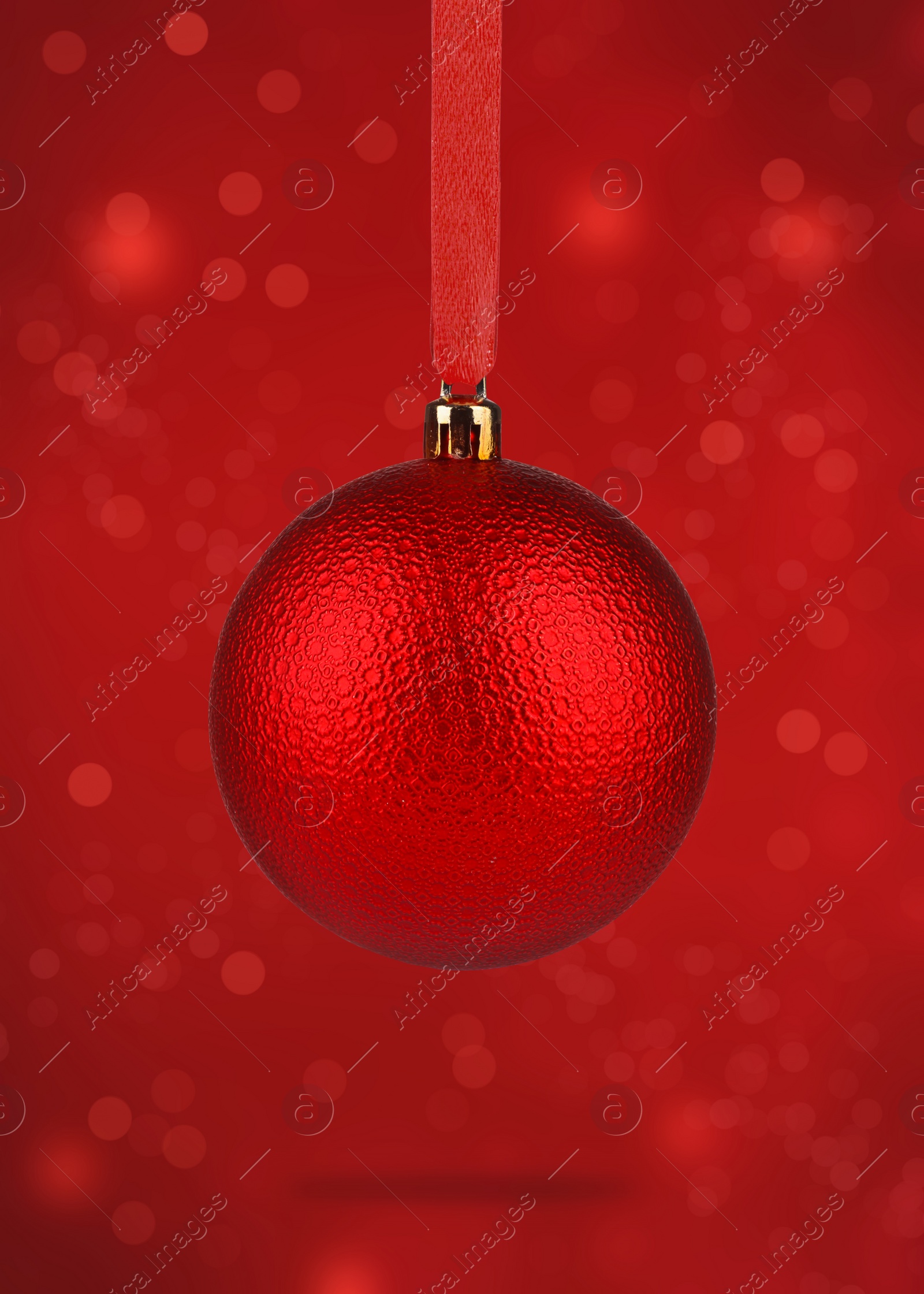 Image of Beautiful Christmas ball hanging on red background