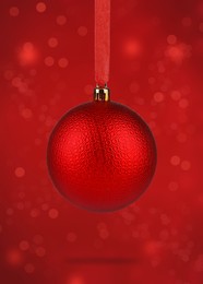 Image of Beautiful Christmas ball hanging on red background
