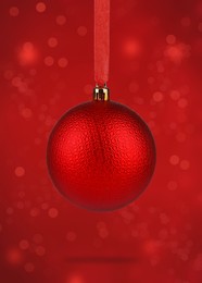 Beautiful Christmas ball hanging on red background