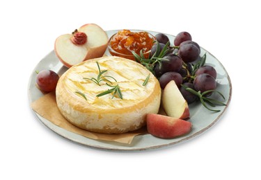 Photo of Tasty baked brie cheese with rosemary, fruits and jam isolated on white