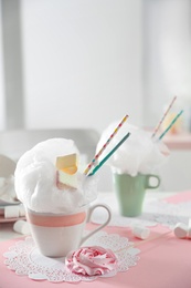 Cup of cotton candy dessert served on table, space for text