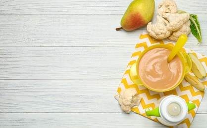 Photo of Healthy baby food and ingredients on white wooden table, flat lay. Space for text