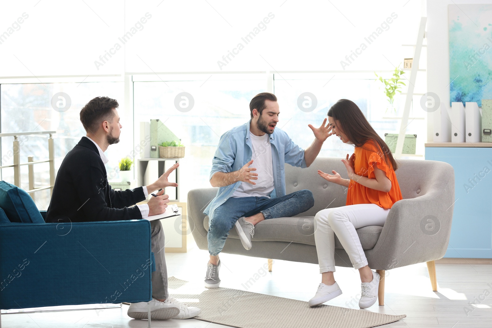 Photo of Family psychologist working with young couple in office