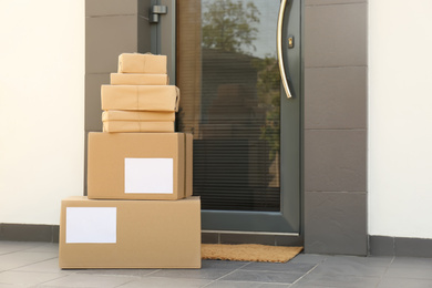 Cardboard boxes near door. Parcel delivery service