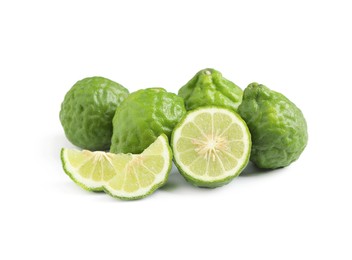 Photo of Whole and cut ripe bergamot fruits on white background