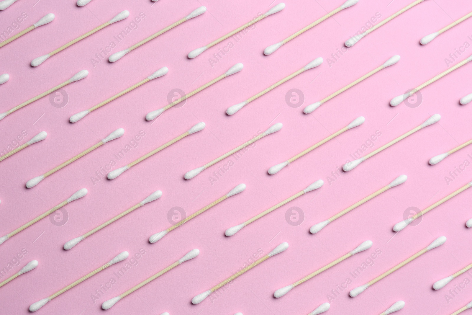 Photo of Many cotton buds on pink background, flat lay