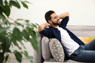 Young man relaxing on couch at home