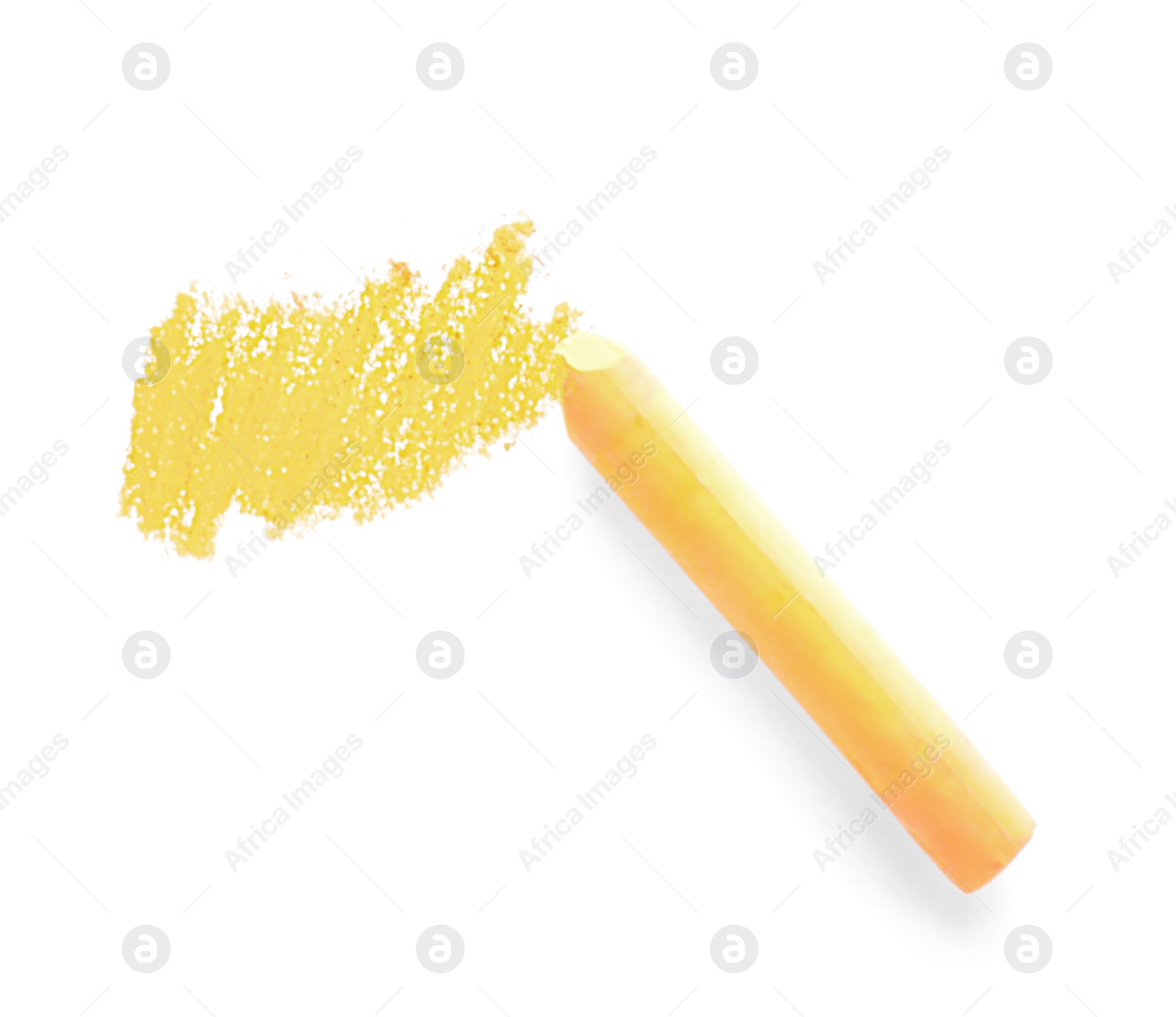 Photo of Yellow pastel chalk on sheet of paper with scribble, top view. Drawing material