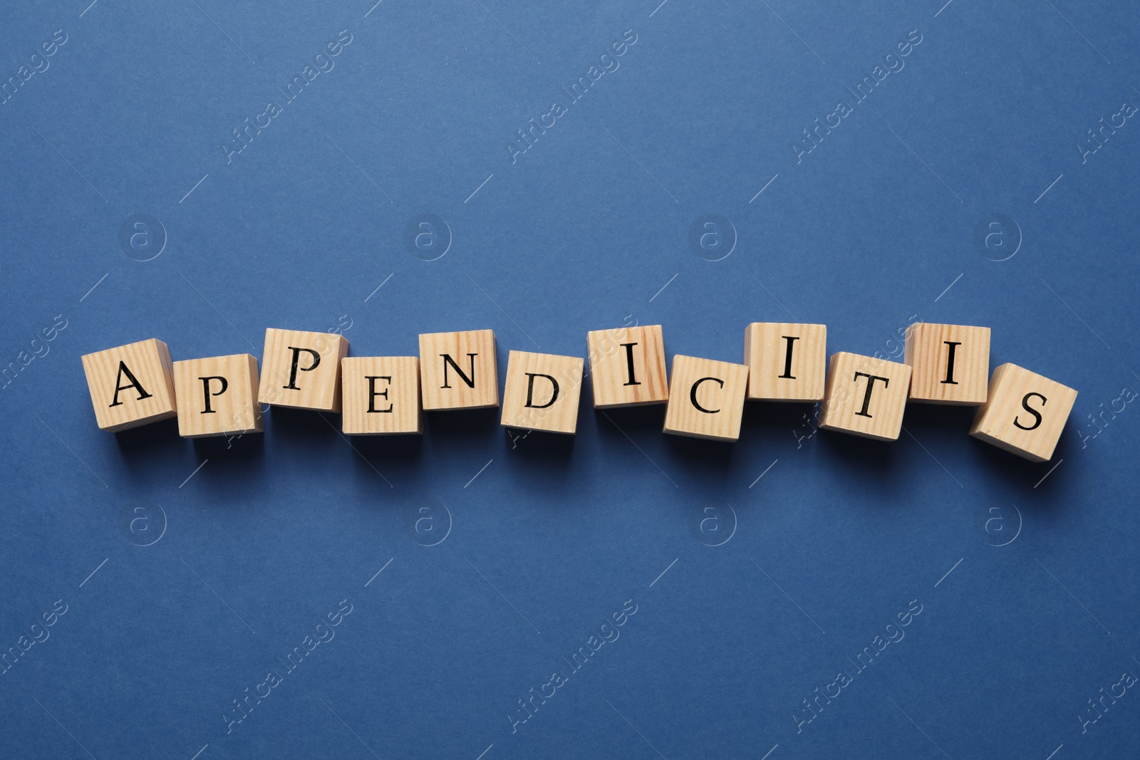 Photo of Word Appendicitis made of wooden cubes with letters on blue background, top view