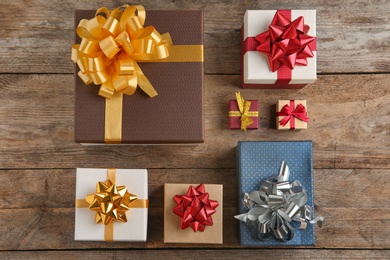 Photo of Flat lay composition with beautiful gift boxes on wooden background