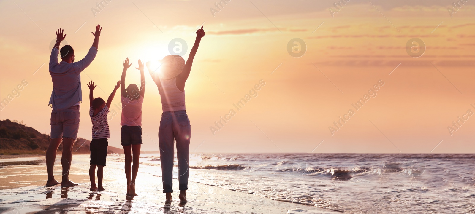 Image of Family on sandy beach near sea at sunset, space for text. Banner design