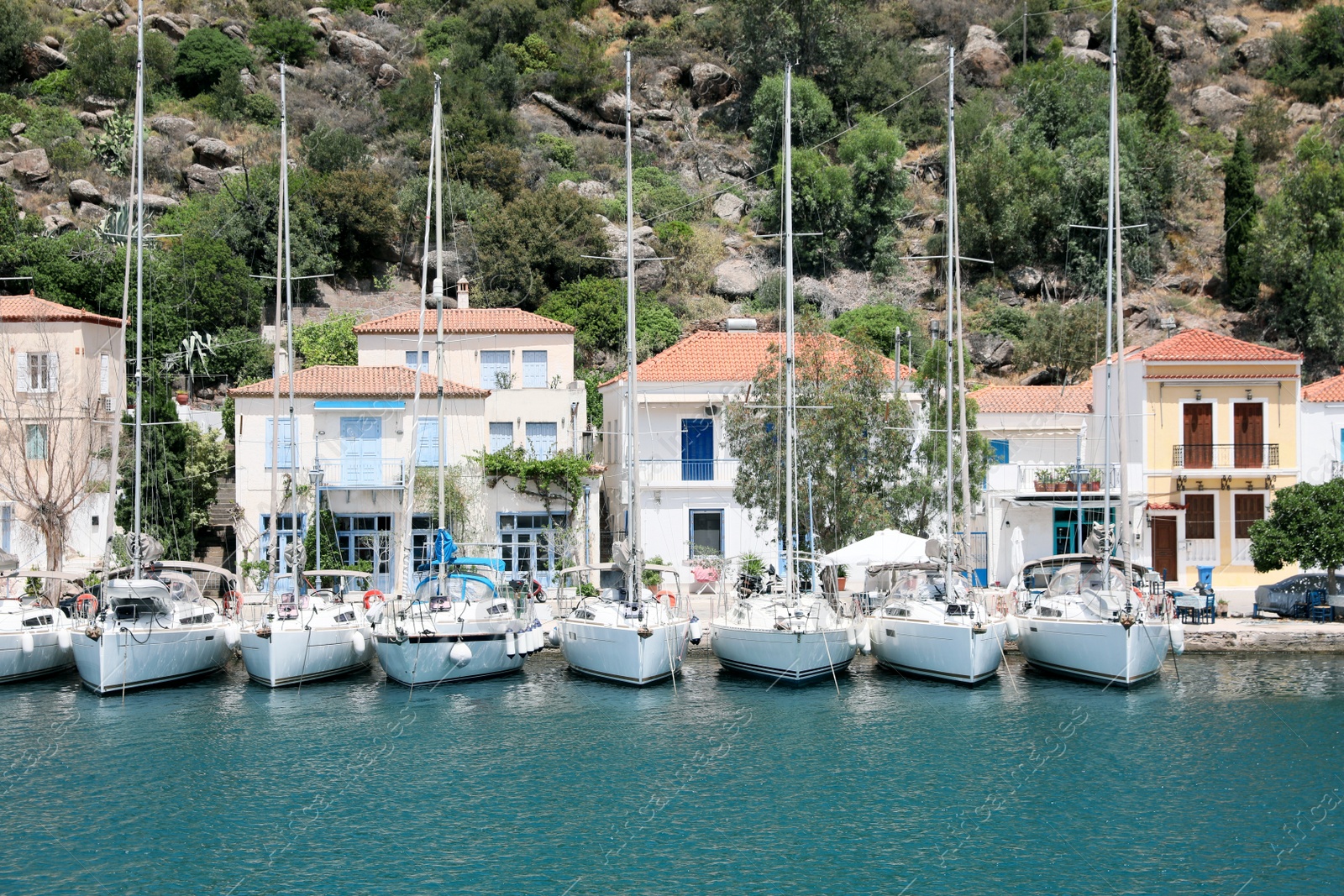 Photo of Beautiful view of coastal city with sailboats on sunny day