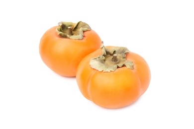 Photo of Whole delicious juicy persimmons on white background