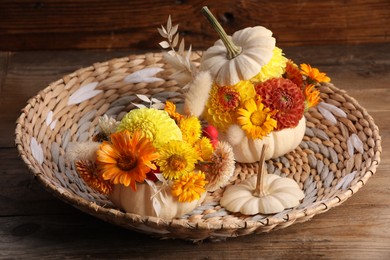 Photo of Composition with small pumpkins, beautiful flowers and spikelets on wooden table, closeup
