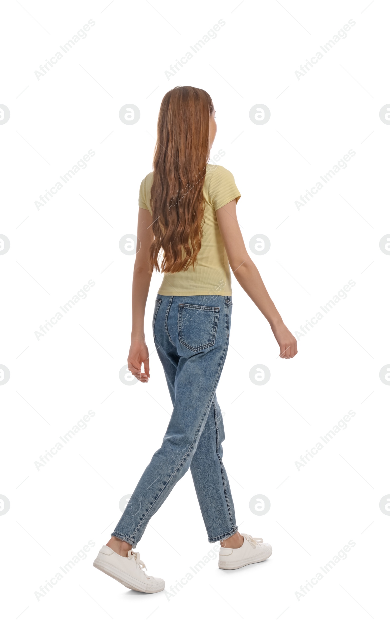 Photo of Young woman in casual outfit walking on white background