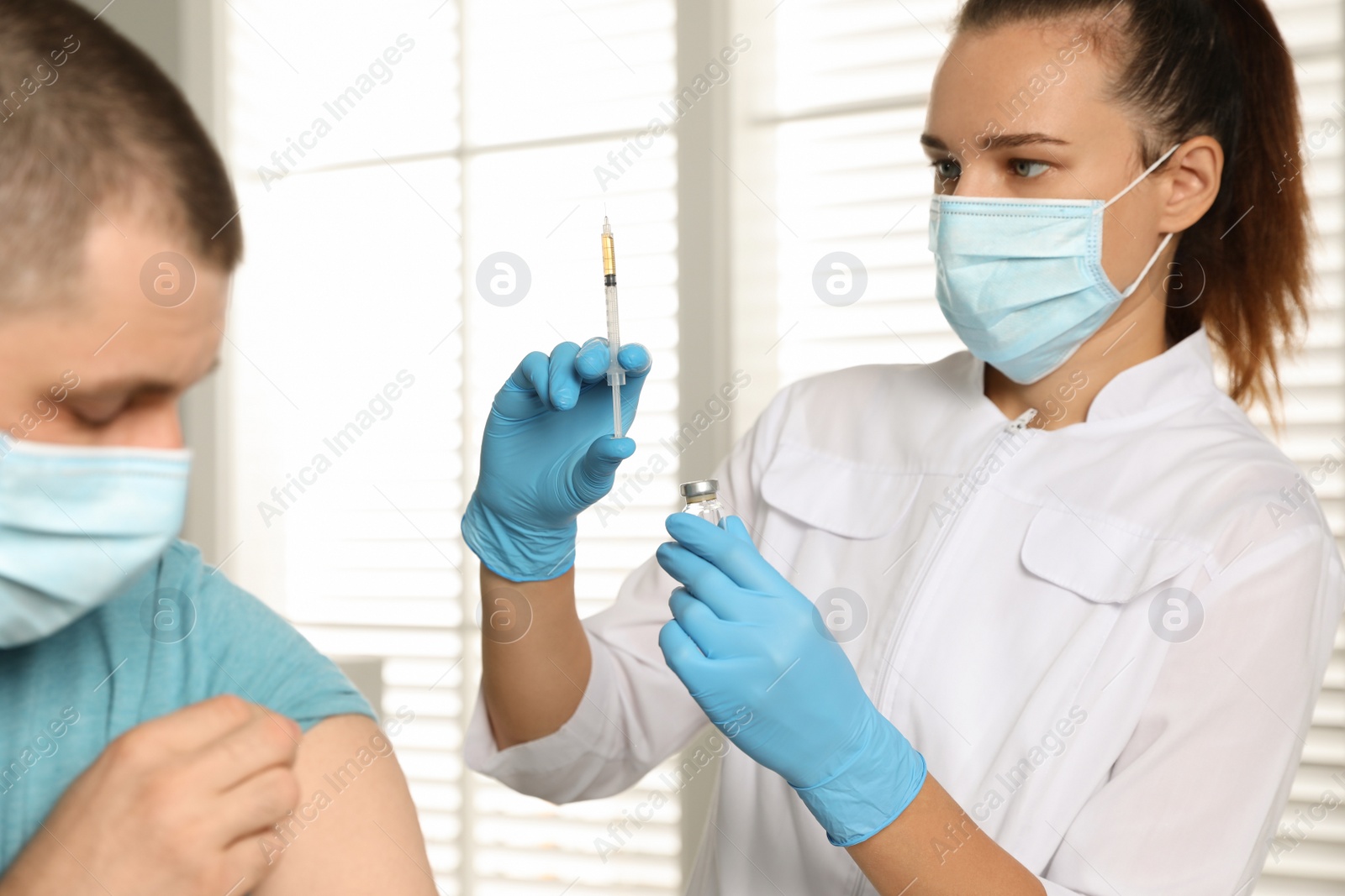 Photo of Doctor giving injection to patient in hospital. Vaccination day