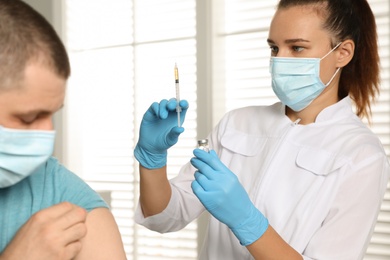 Doctor giving injection to patient in hospital. Vaccination day