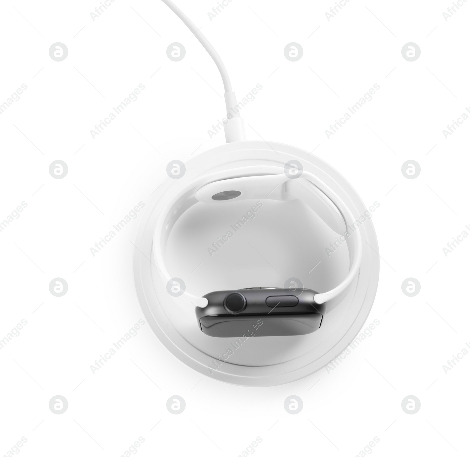 Photo of Smartwatch charging with wireless pad on white background, above view
