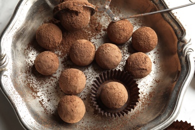 Photo of Plate with tasty chocolate truffles on table , top view