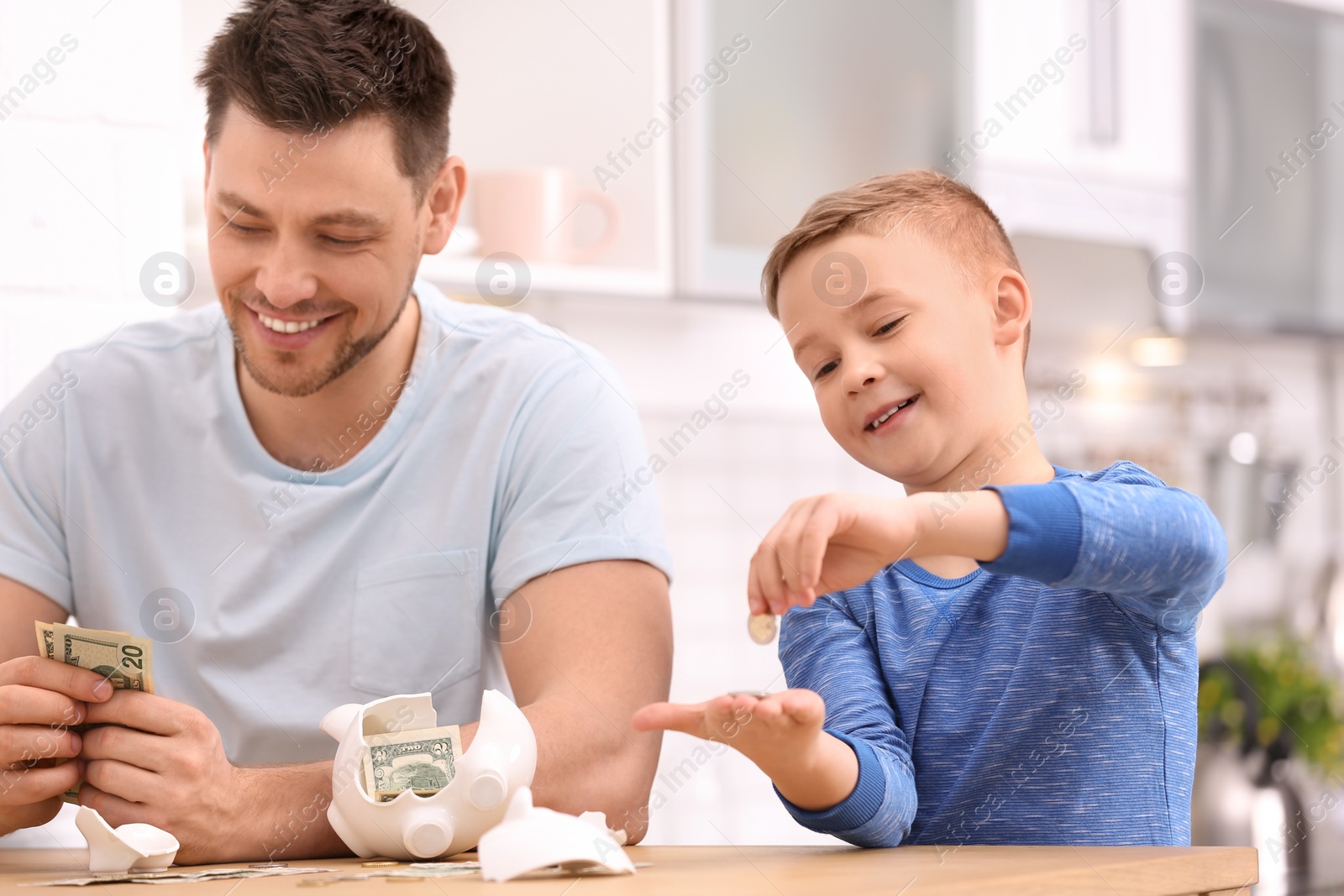 Photo of Family with broken piggy bank and money at home